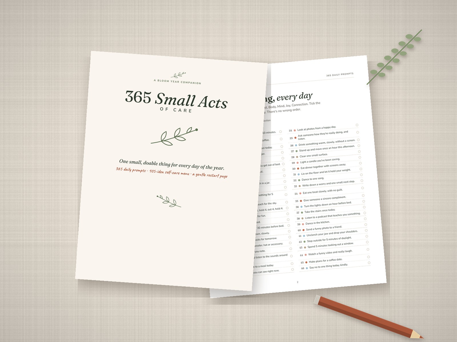 The cover of 365 Small Acts of Care next to an open page of daily self-care prompts